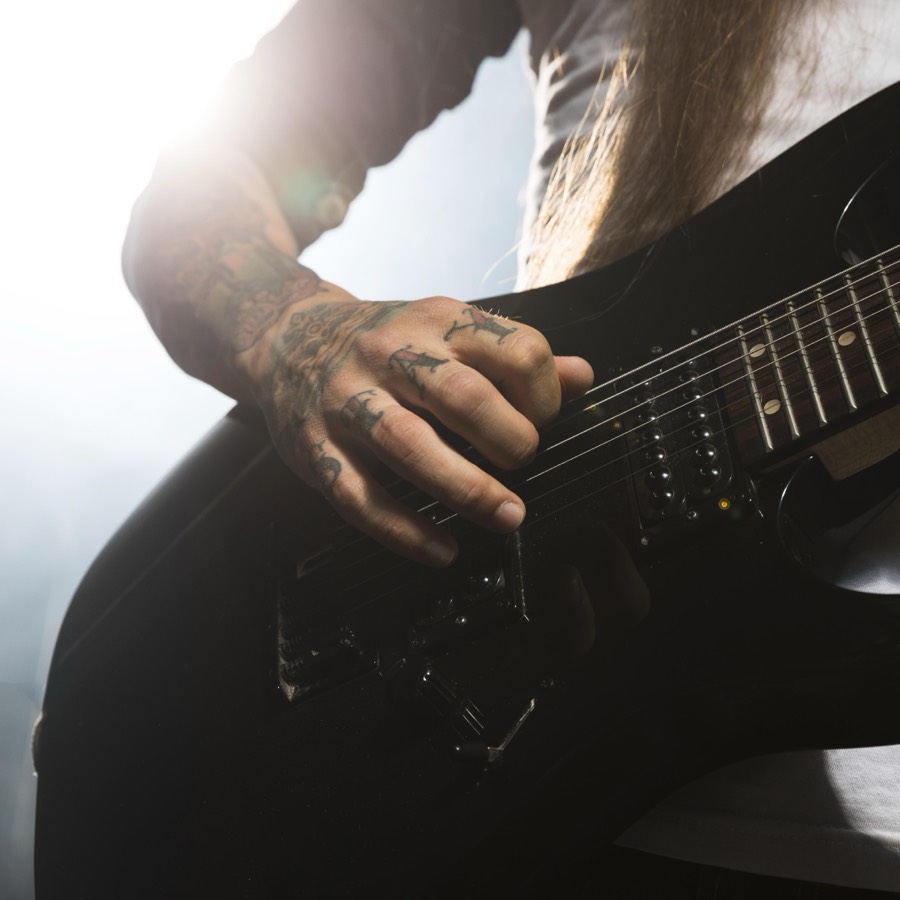 Close-up of hands playing an acoustic guitar