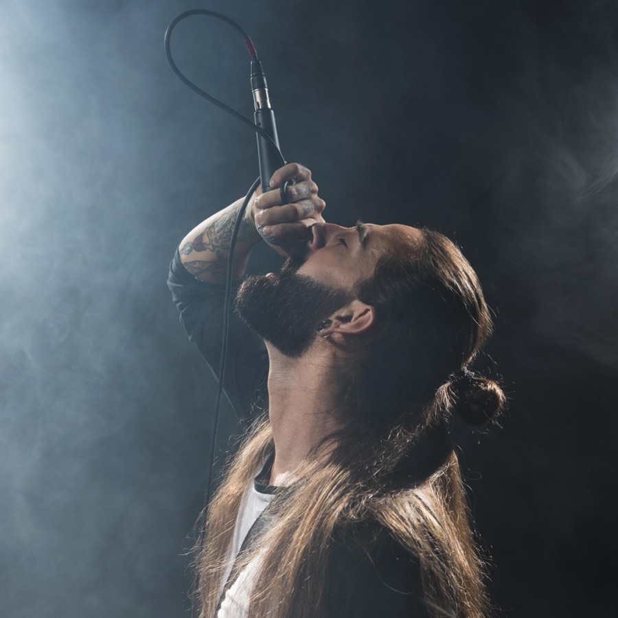 A performer singing on a small stage